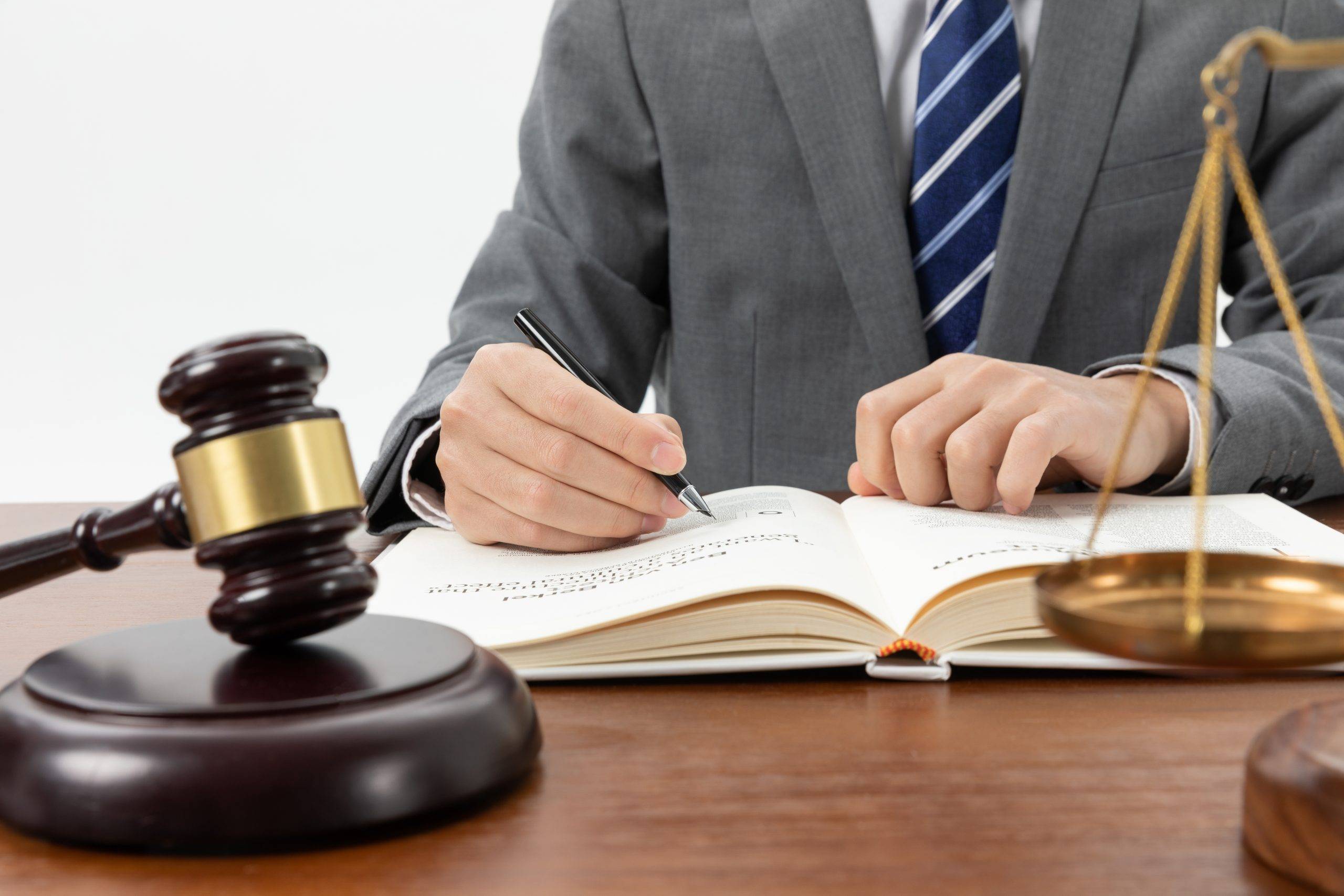 closeup shot person writing book with gavel table scaled LEGAL ESSENTALS FOR IMPORTERS: CONTRACTS, IP PROTECTION, AND DISPUTE RESOLUTION