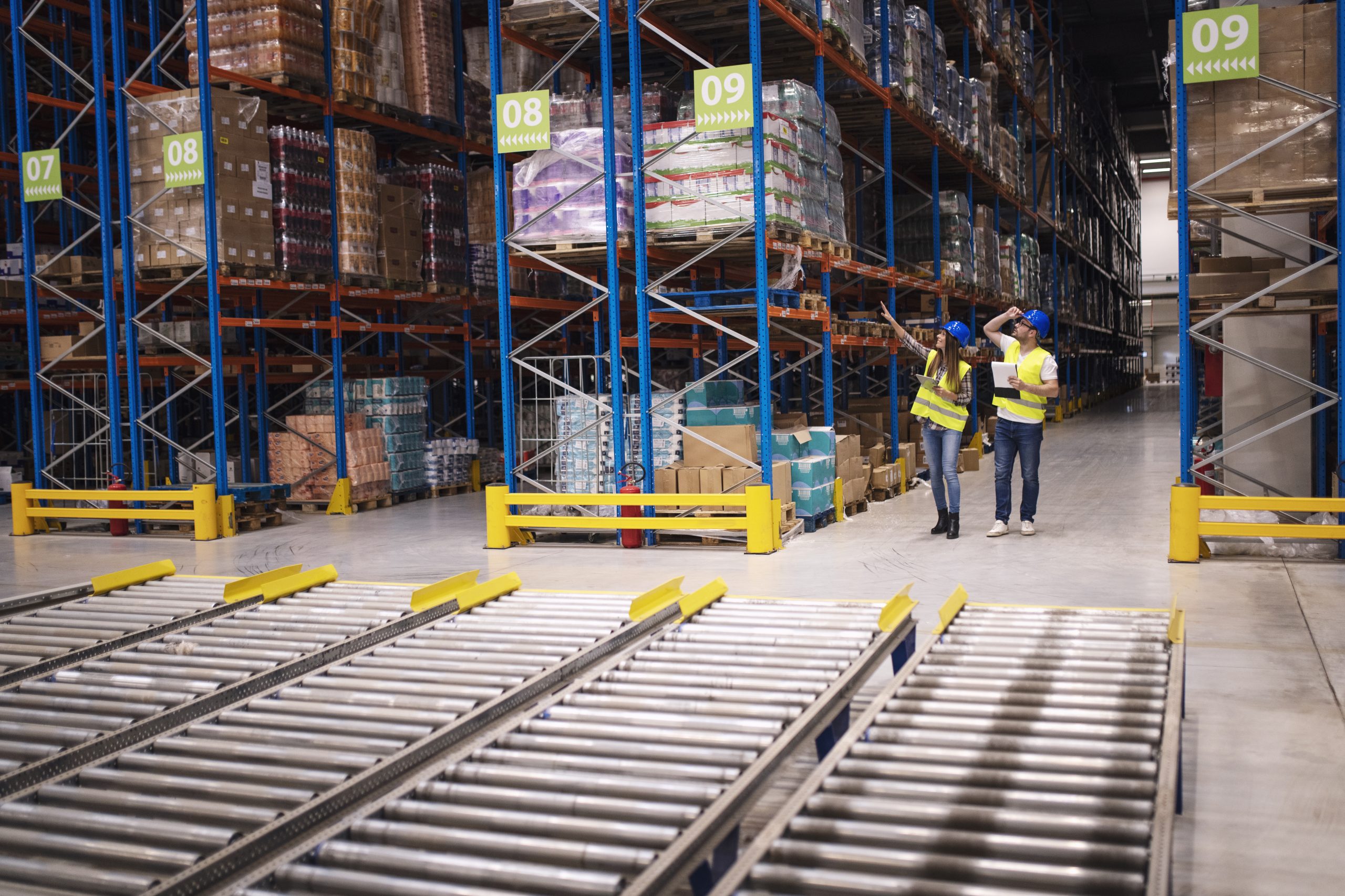 Warehouse workers checking inventory and goods distribution in large storehouse. warehouse workers checking inventory goods distribution large storehouse scaled About Us