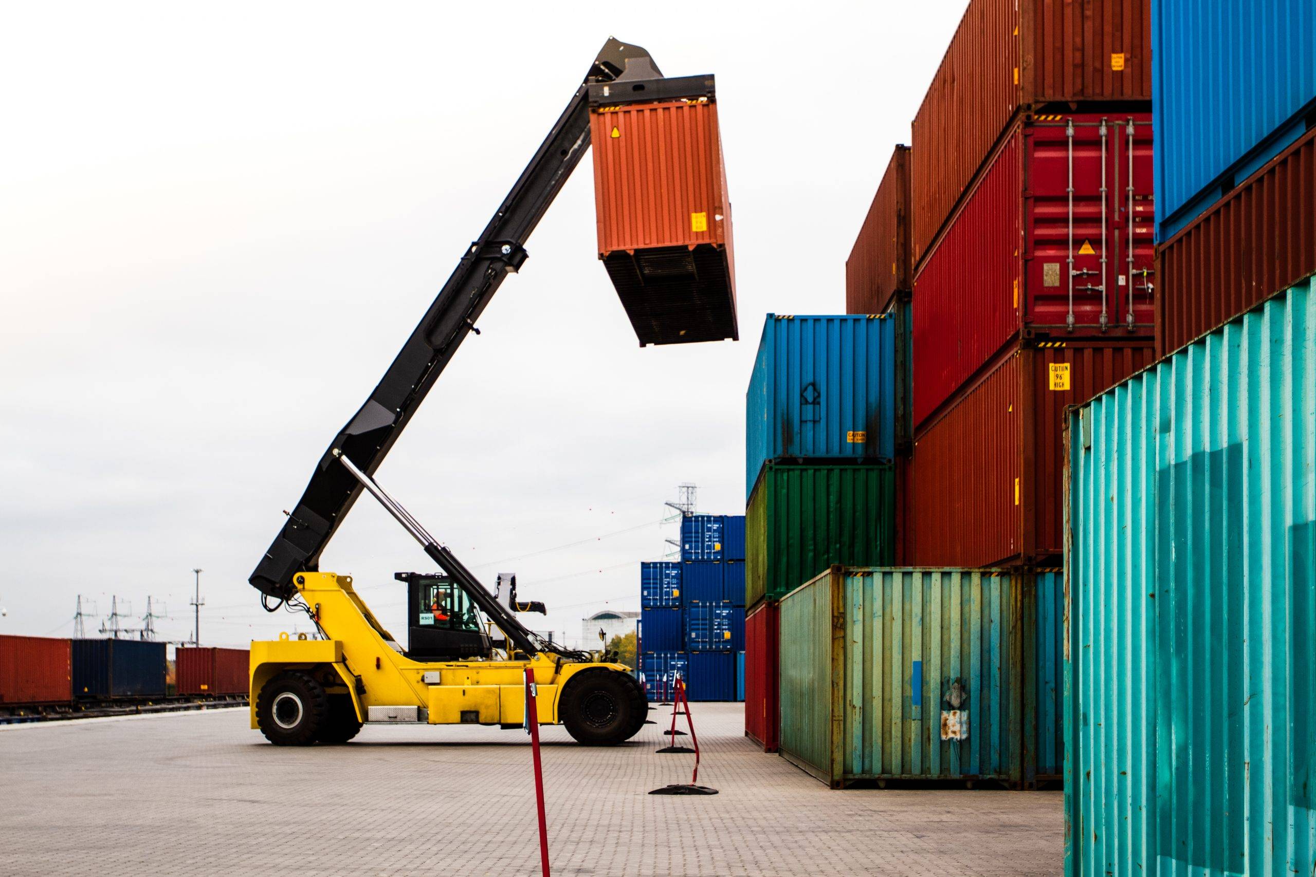 forklift handling cargo container freight container loading container handler logistics import export concept industrial container logistic yard scaled SEA SHIPPING TERMS EXPLAINED: GATE-IN, ETA, ETD, AND HOW TO MONITOR CONTAINER ARRIVAL TIME